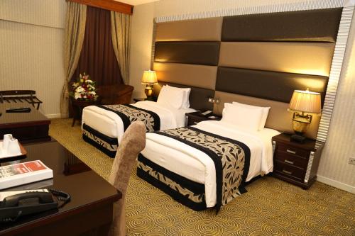 Postel nebo postele na pokoji v ubytování ABJAD CROWN HOTEL