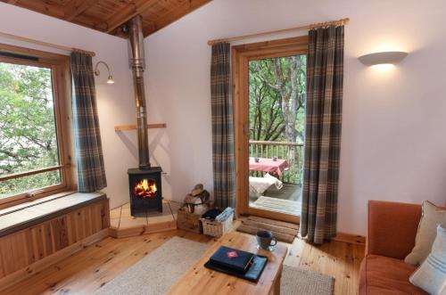 a living room with a fireplace and a couch at Down House in Torridon