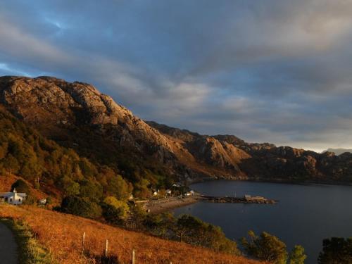 a view of a lake with mountains in the background at Down House in Torridon