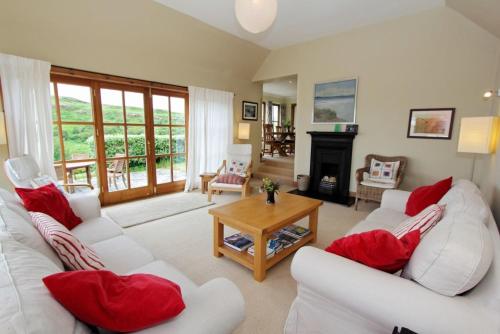 a living room with two white couches and a table at Saltwinds in Carbost