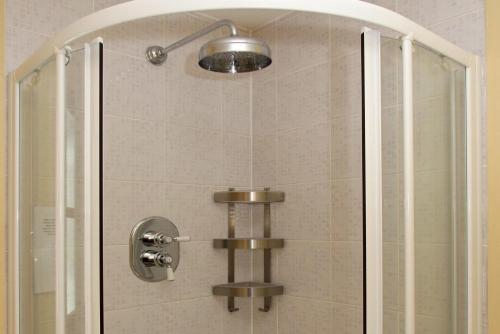 a shower with a glass door with a shower head at Saltwinds in Carbost