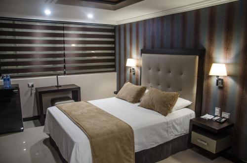 Postel nebo postele na pokoji v ubytování Hotel Veuxor
