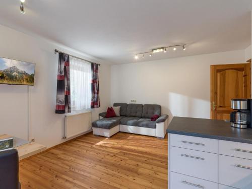 a kitchen and a living room with a couch at Appartement Melodie in Scheffau am Wilden Kaiser