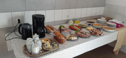 a kitchen counter with a bunch of food on it at Noclegi nad Biebrzą Stara Szkoła in Wroceń