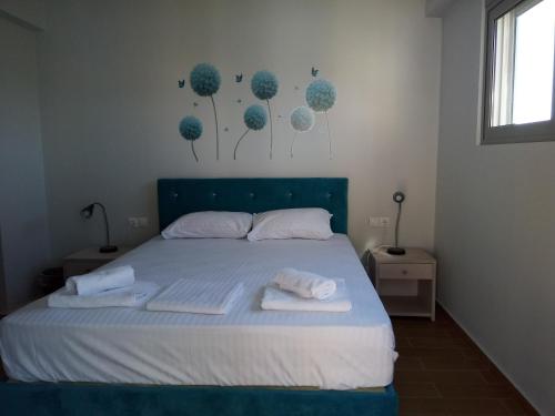 a bedroom with a bed with two towels on it at Armonia Studios Preveza in Preveza