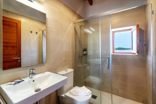 a bathroom with a shower and a sink and a toilet at Cas Saliners - Ses Illetes in La Savina