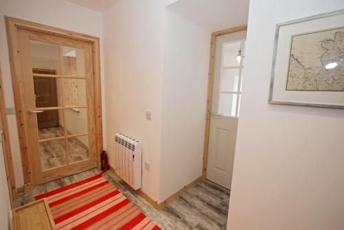 a room with a hallway with a door and a rug at Taigh Eachainn in Valtos