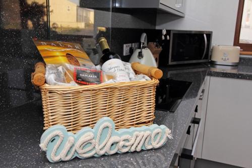 a basket of food and wine on a kitchen counter at Conan Mara in Eriskay