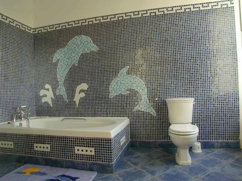 a bathroom with a bath tub and a toilet at Cortes House in Fraserburgh