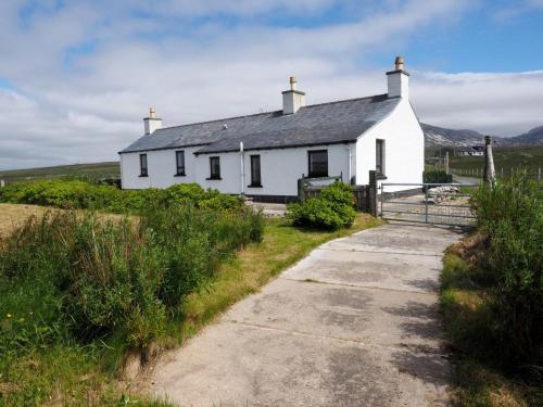 a white house on the side of a hill at Spindrift in Brenish