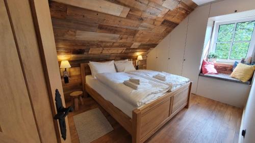 A bed or beds in a room at Lake House Podwilczyn with sauna, beach, amazing view, forests and bikes