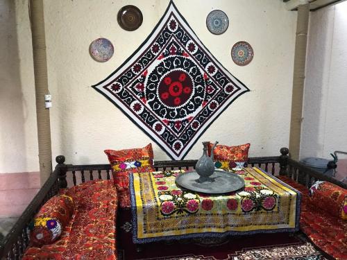 a bed with a table and pillows on it at Hotel Han in Samarkand