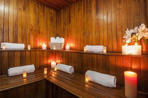 a sauna with candles and towels on a wooden wall at Hotel Almirante Cartagena Colombia in Cartagena de Indias
