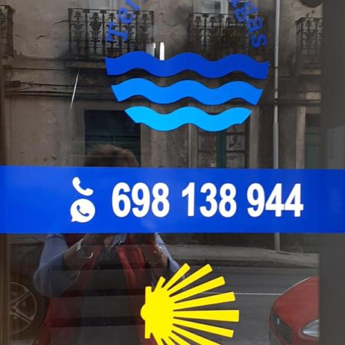 a reflection of a person in a window at Apartamento TerradeAugas3 in Caldas de Reis