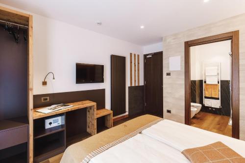 Ένα ή περισσότερα κρεβάτια σε δωμάτιο στο Albergo Centrale