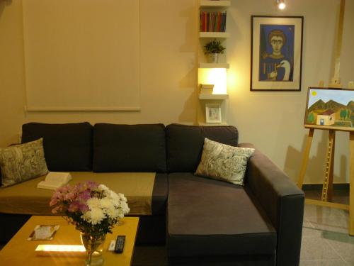a living room with a couch and a table at Agnanti Apartments in Argaka