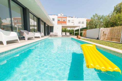 a swimming pool with a yellow slide in a house at Villa 91 by ALGARTUR in Tavira