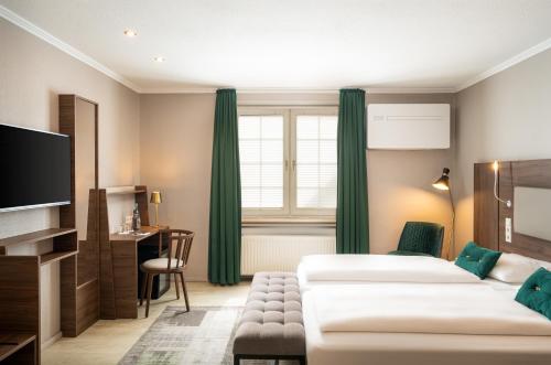 a hotel room with two beds and a television at Arthotel ANA Liberty Bremen City in Bremen
