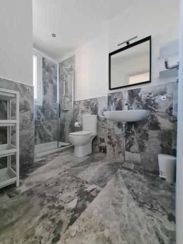 a bathroom with a sink and a toilet and a mirror at 180Passi B&B in Lido Marini