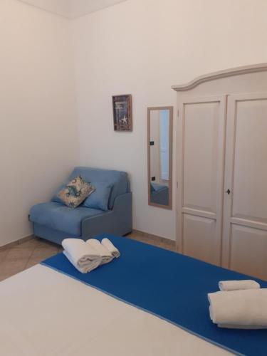 sala de estar con sofá azul y espejo en Casa du Piscature, en Favignana