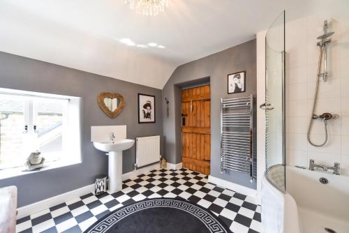 a bathroom with a shower and a sink and a toilet at Old Horns Cottage, Higham Derbyshire in Alfreton