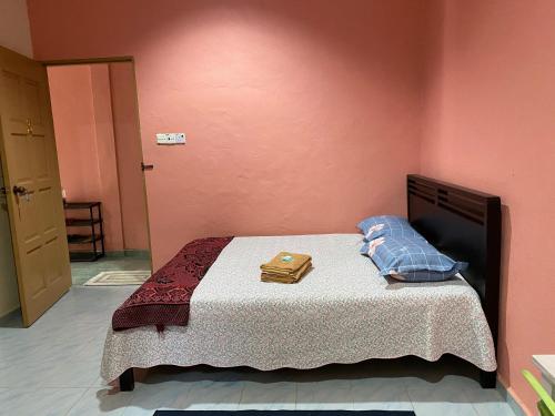 a bedroom with a bed with a suitcase on it at Bilik Harian Pengkalan Chepa in Pengkalan Cepa