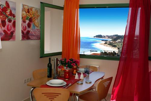 a dining room table with a view of the ocean at Villa Brio in Skala Kefalonias
