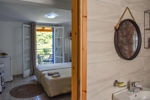 a bedroom with a bed and a mirror on the wall at BONSAI in Skiathos Town