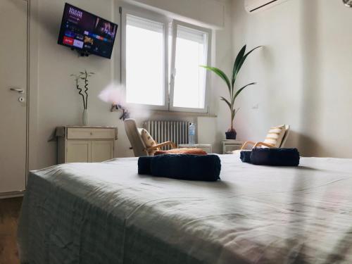 a bedroom with a large bed with two blue pillows on it at Stanza e idromassaggio, con extra fee, in delizioso appartamento in Ferrara