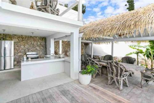 a kitchen and dining area of a villa at Luxury Villa in Lowlands, Sea View in Lowlands
