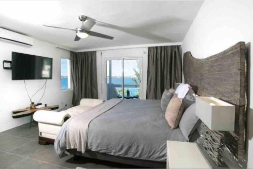 a bedroom with a large bed and a television at Luxury Villa in Lowlands, Sea View in Lowlands