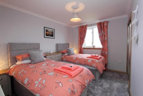 A bed or beds in a room at Machair Cottage