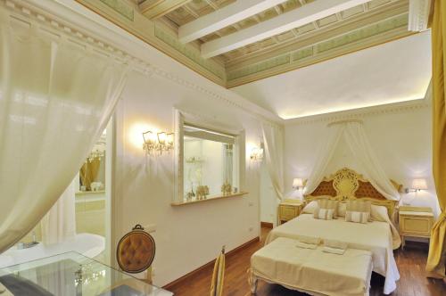 a large bedroom with a bed and a mirror at The Right Place 4U Roma Savelli Boutique Apartment in Rome