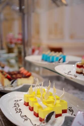 a piece of cake on a plate on a table at Mövenpick Hotel City Star Jeddah in Jeddah