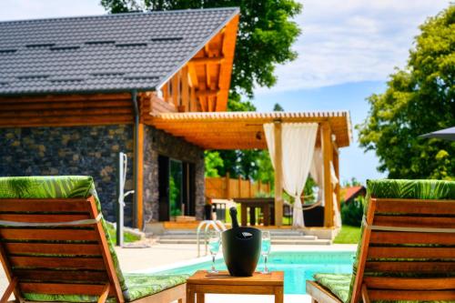 a patio with two chairs and a pool at Holiday Home Wellspring in Jastrebarsko