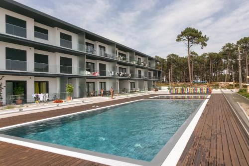 a swimming pool in front of a building at Nazaré Sea View Apartment in Nazaré