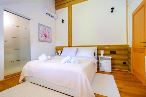a bedroom with a large white bed with white sheets at Holiday Home Wellspring in Jastrebarsko