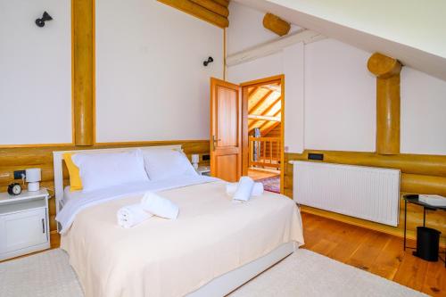 a bedroom with a large white bed with white pillows at Holiday Home Wellspring in Jastrebarsko