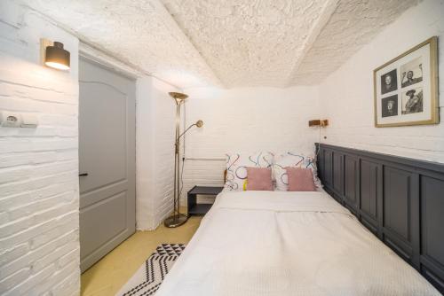 a bedroom with a large bed with pink pillows at Ádám Apartman in Balatonföldvár