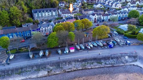 an aerial view of a city with boats in a parking lot at Extended Fishermans cottage with stunning sea views in The Mumbles