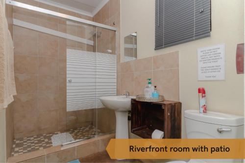 a bathroom with a toilet and a sink and a shower at Crocodile Bridge Safari Lodge in Komatipoort