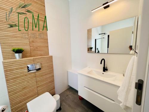 a bathroom with a sink and a mirror at LOMA in Hagoshrim