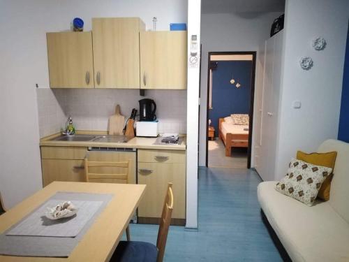 a kitchen and a living room with a table at Apartments Marija in Pirovac