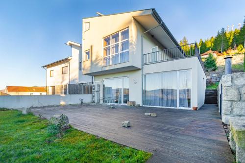 a house with a large deck in front of it at Casa da Corujeira - Montalegre in Montalegre