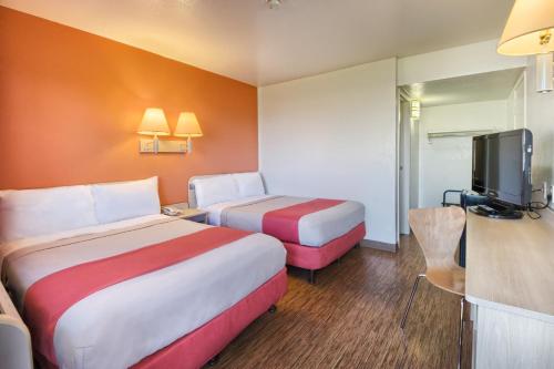 a hotel room with two beds and a television at Motel 6-Pendleton, OR in Pendleton