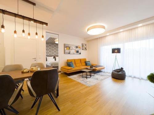 a living room with a table and a couch at VIVA Apartments in Graz