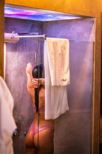 a naked woman in a shower with a towel at Adriatic Spa in Novi Sad