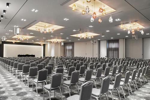 a large room with rows of chairs and a screen at Grand Hotel Palace in Thessaloniki