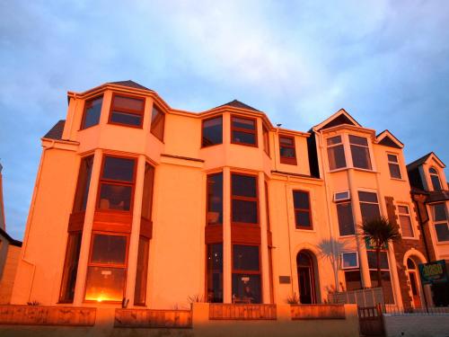 a large orange building with a lot of windows at Aqua Shack at Pure Shores Retreats in Newquay