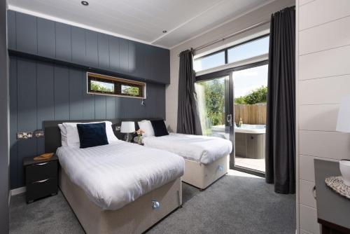 Una cama o camas en una habitación de Primrose Lodge, 25 Roadford Lake Lodges